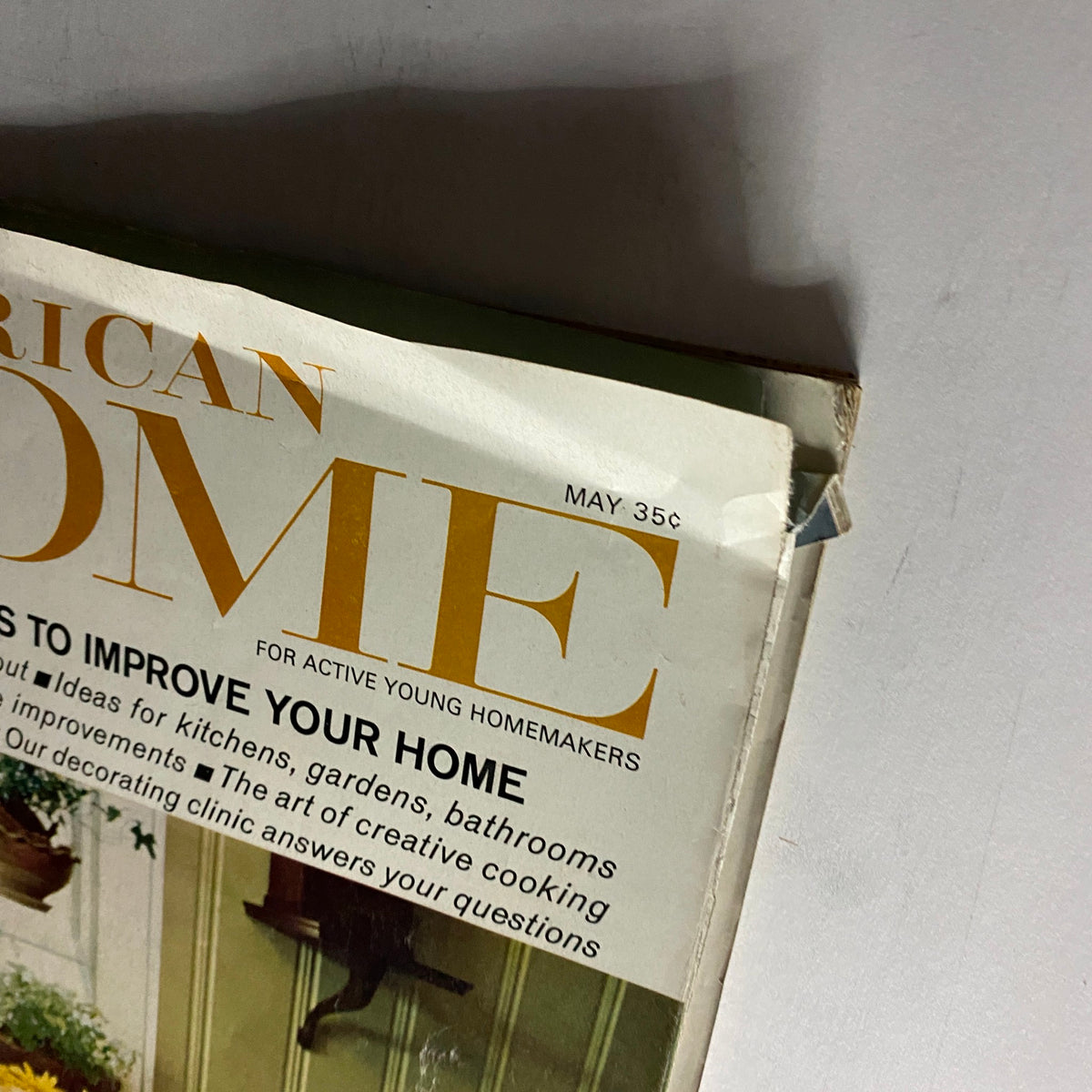 Close-up view of the cover of VTG American Home Magazine May 1967, showing the title 'Exciting Ways To Improve Your Home' and detailing home improvement advice for kitchens, gardens, and more.