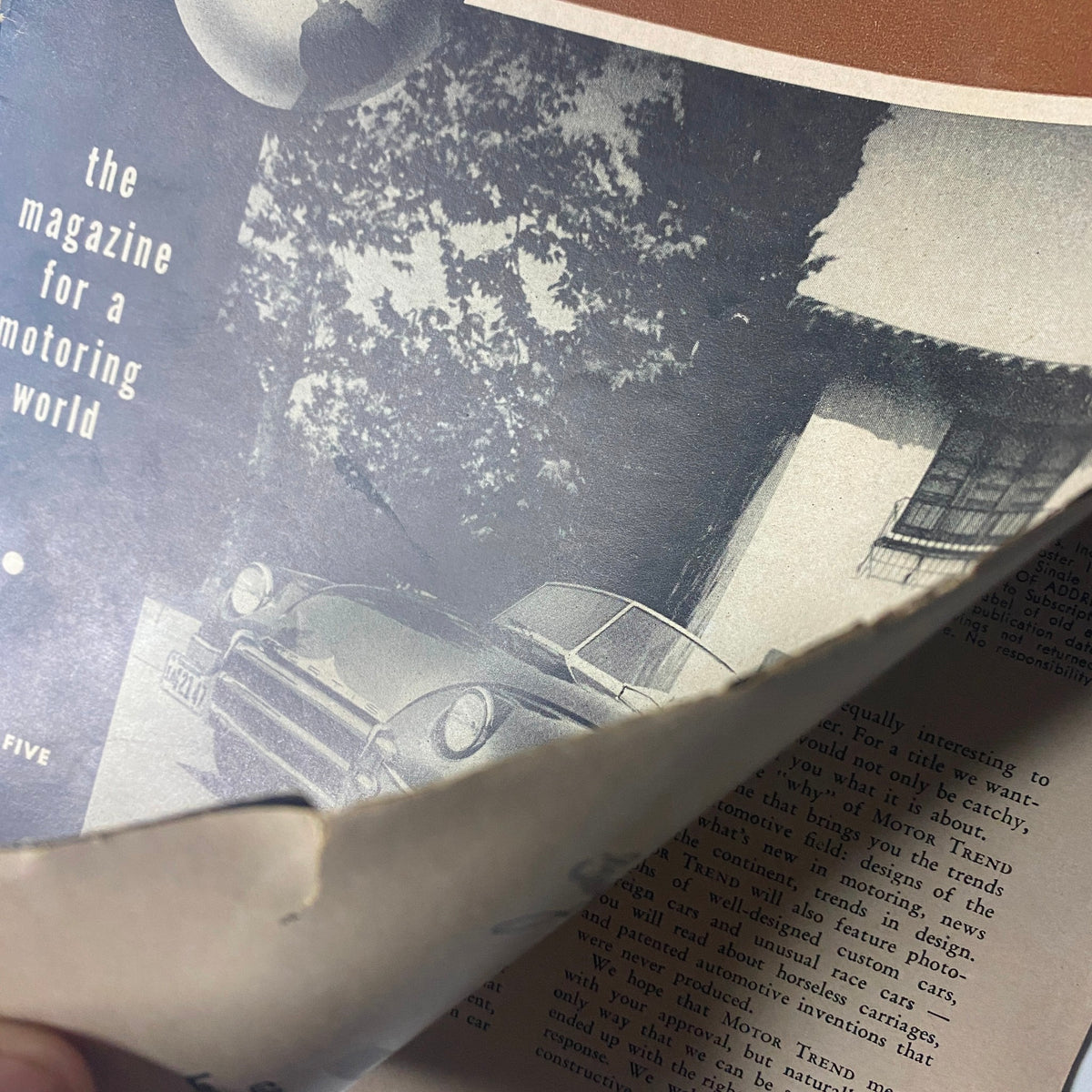 Close-up of the cover of Motor Trend Magazine September 1949, revealing damage and details while highlighting its significance as the first issue.