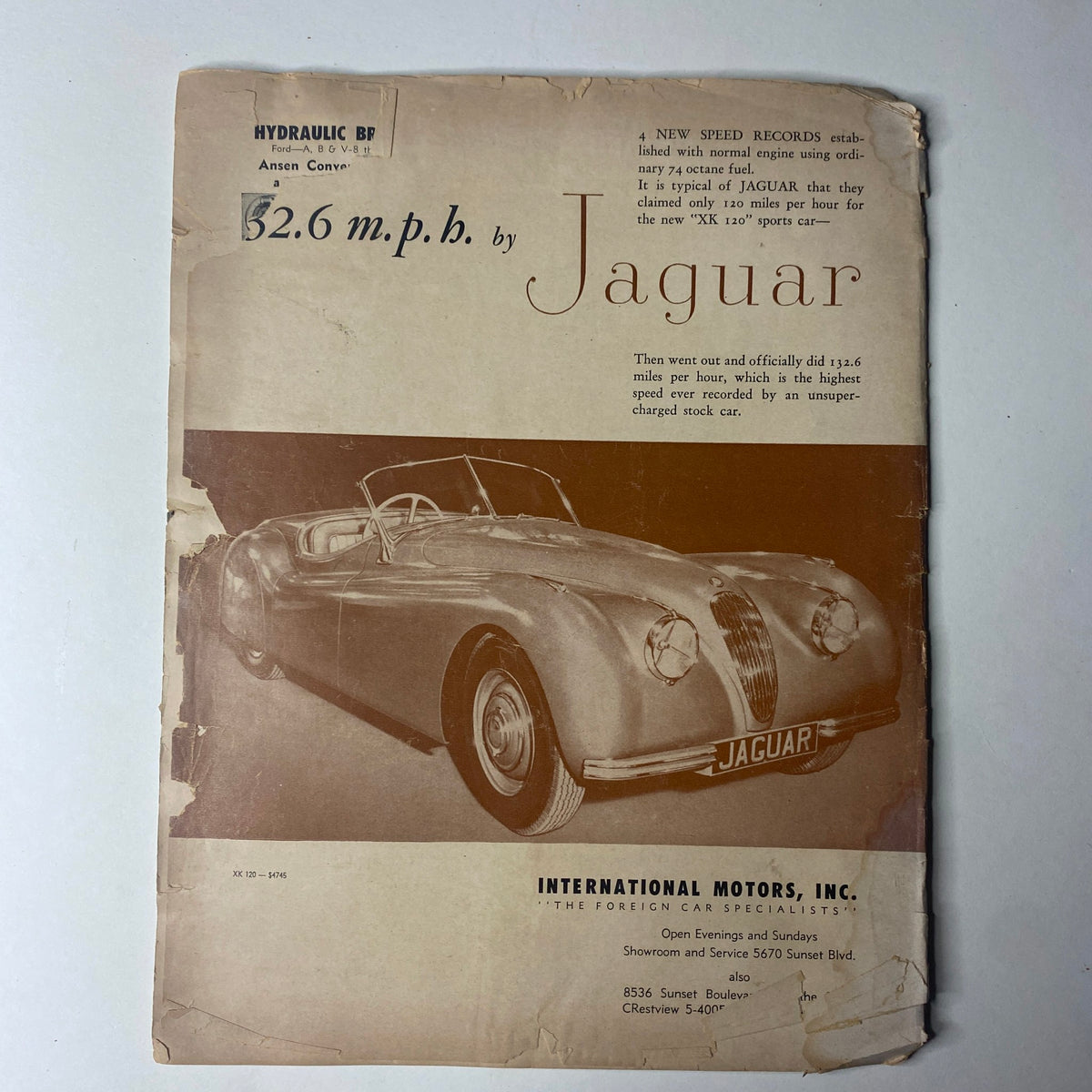 Back cover of Motor Trend Magazine, September 1949, highlighting a Jaguar advertisement emphasizing speed records.