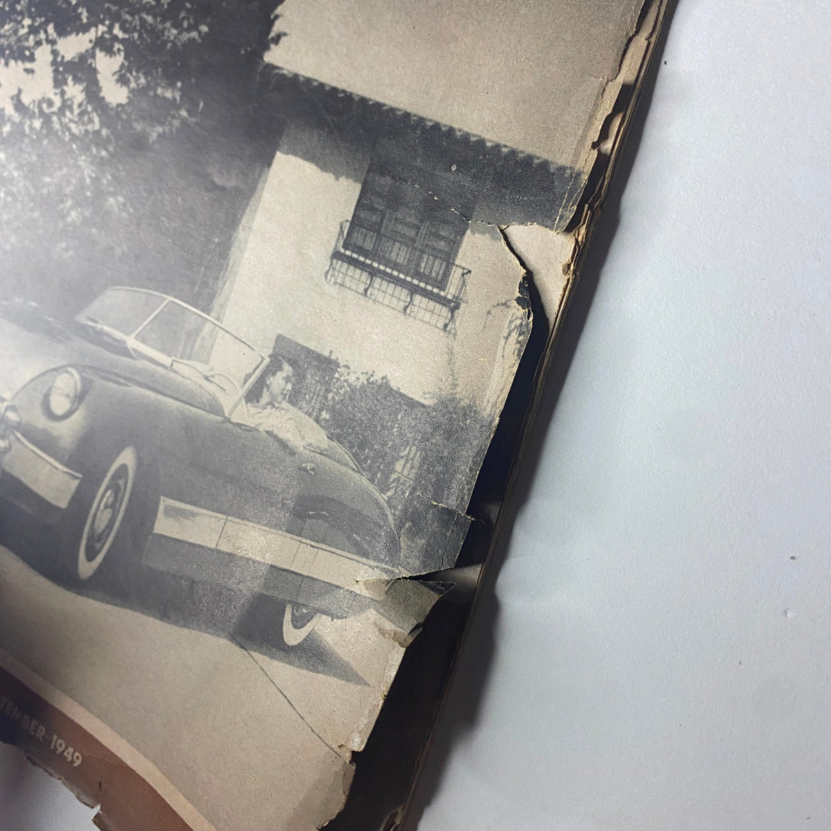 Side view of the Motor Trend Magazine September 1949 featuring the Kurtis Sport Car, showcasing the magazine's cover with creases and markings.