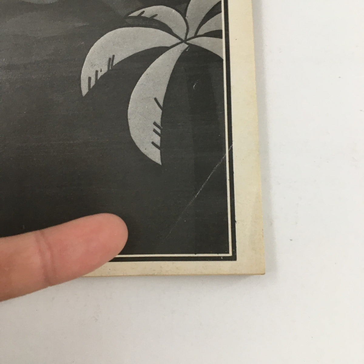 Close-up of the right edge of the 1984 Playbill for 'Hurly Burly' showcasing the palm design and minor age-related wear.