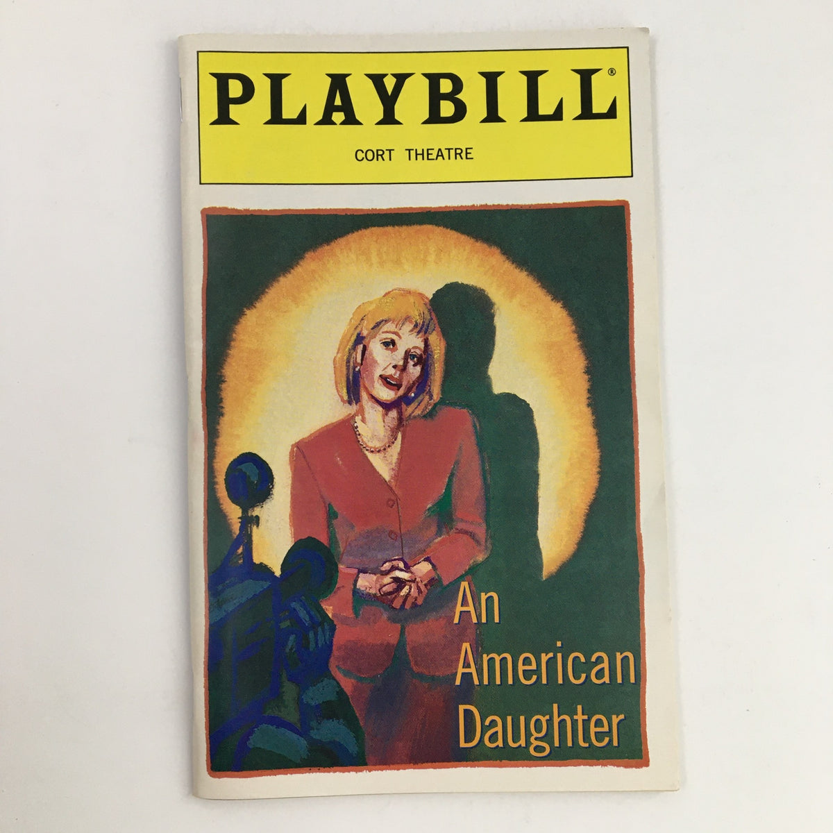 1997 Playbill for Court Theatre's production of An American Daughter by Wendy Wasserstein, featuring a colorful illustration of a performer in a spotlight.