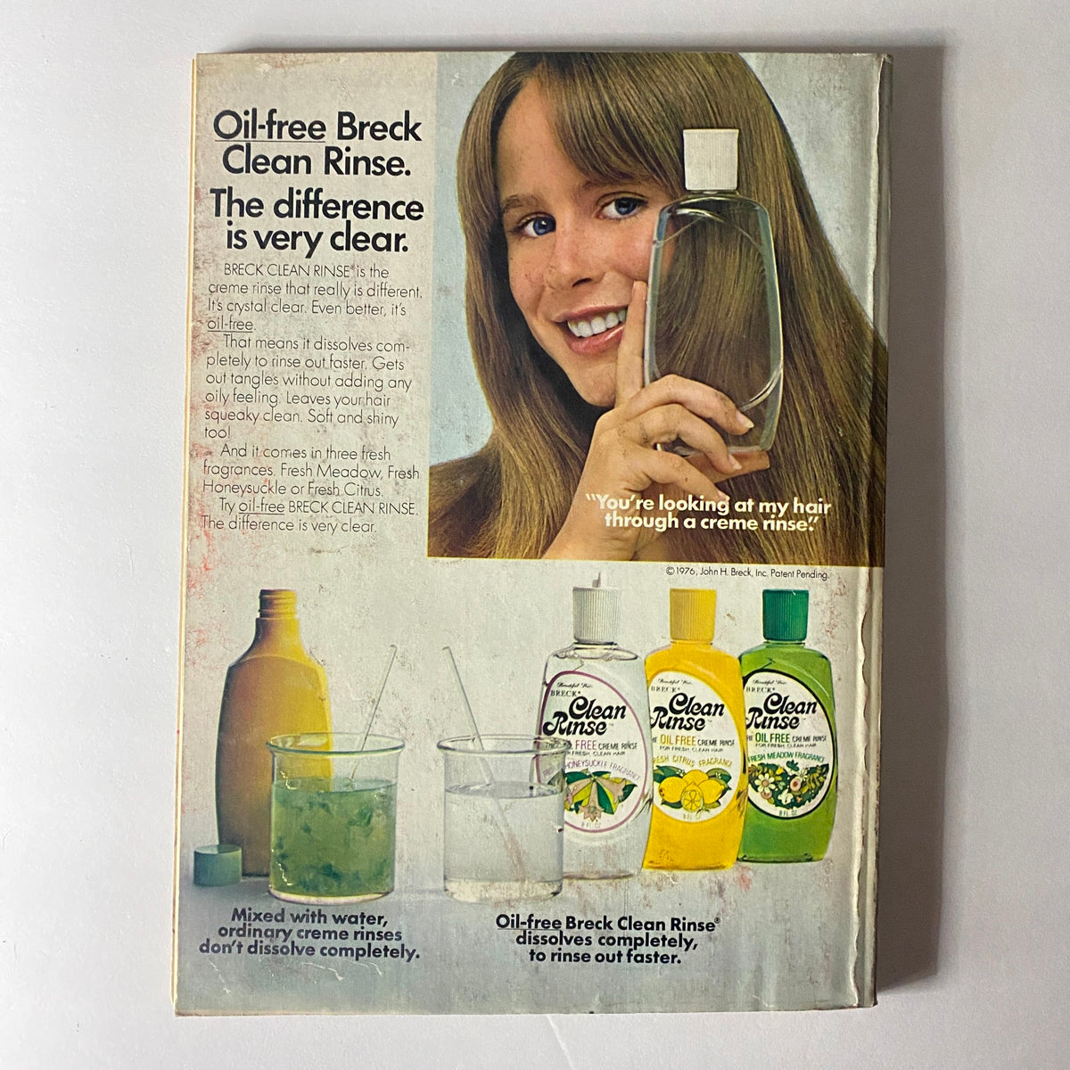 Back cover of the Vintage Seventeen Magazine November 1976 advertising oil-free Breck Clean Rinse with a model promoting the hair care product.