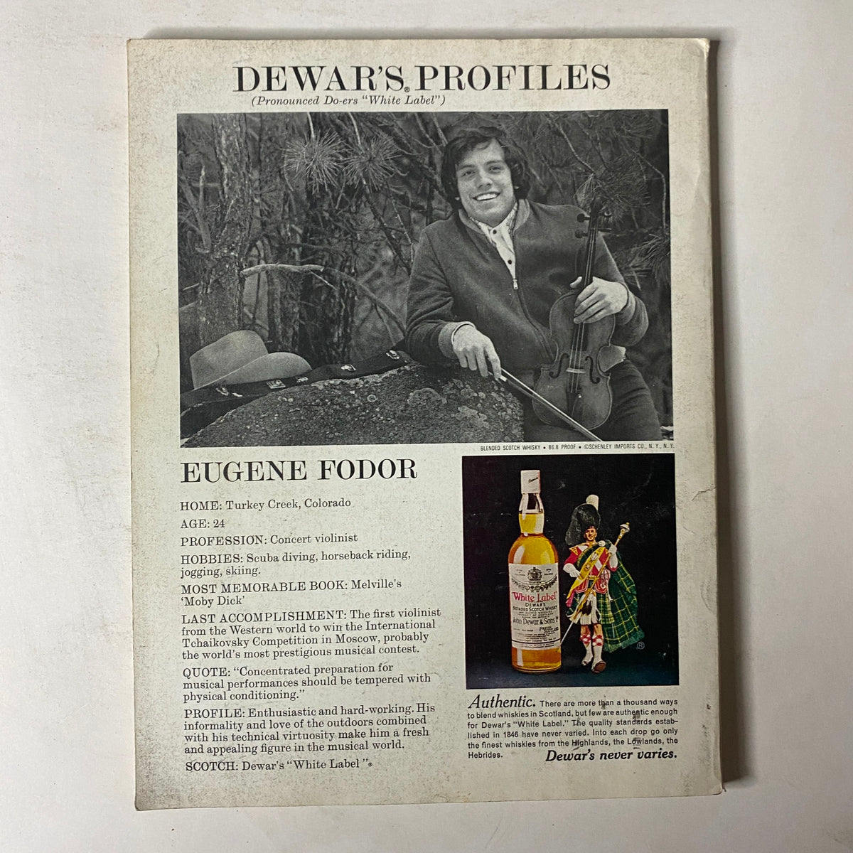 Eugene Fodor profile featuring personal details, a photo of the accomplished violinist, and a bottle of Dewar's White Label Scotch whiskey. The layout emphasizes his background in music and notable achievements. GQ Magazine – October 1975 – Nina Gaidarova & Paul Palmero Cover.