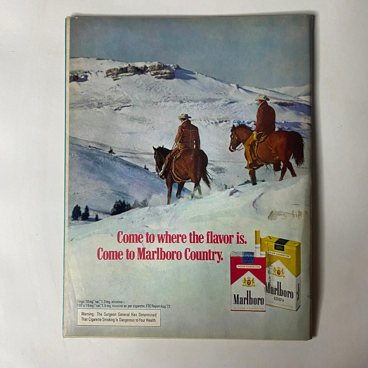 Vintage advertisement featuring cowboys on horseback against a snowy landscape, promoting Marlboro cigarettes with the tagline 'Come to where the flavor is. Come to Marlboro Country.' from the December 1972 issue of Car Craft Magazine.