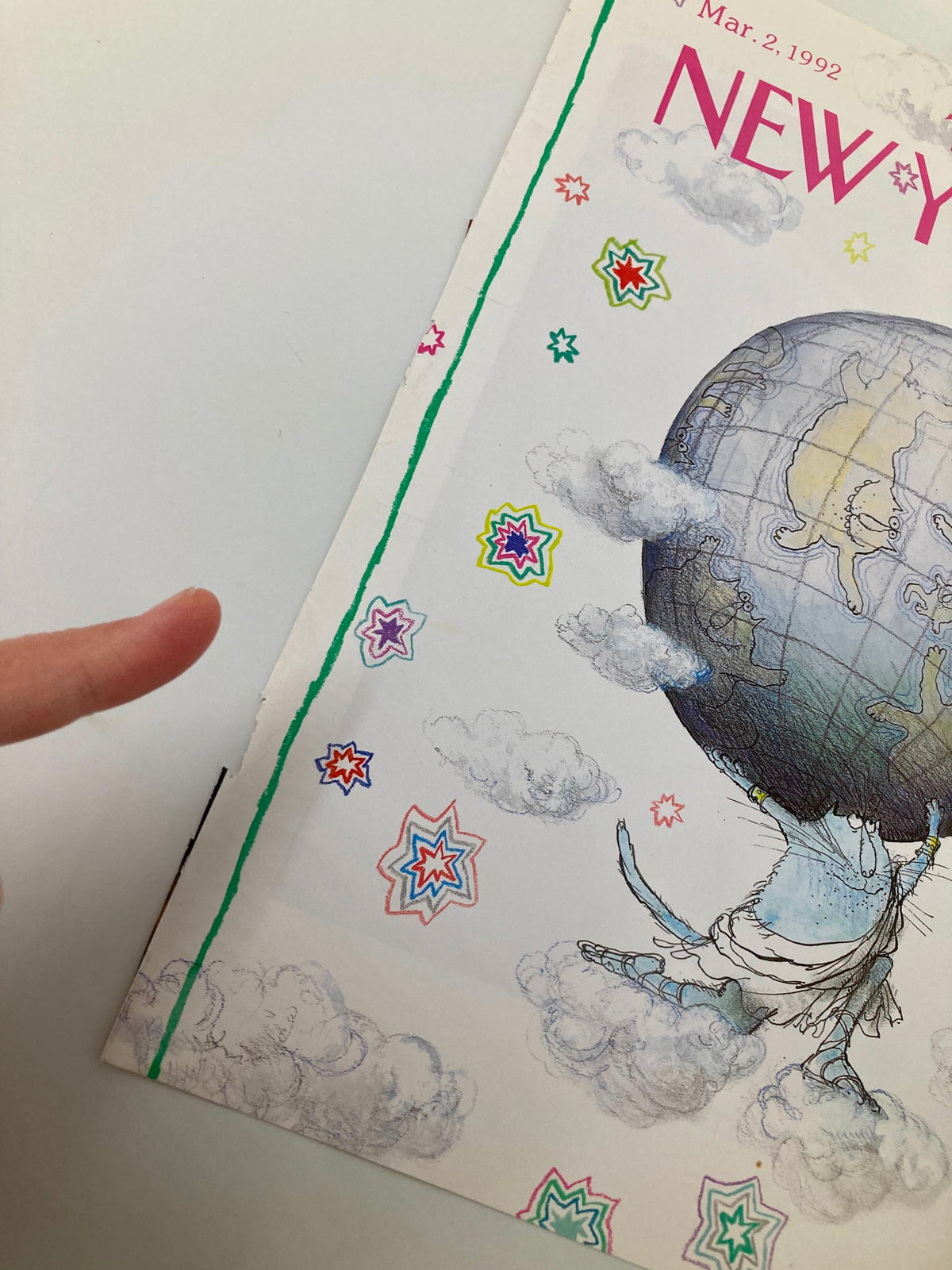 Close-up view of the cover of The New Yorker March 2, 1992, highlighting the detailed illustration 'Planet of the Cats' by Ronald Searle, showcasing a blue cat supporting the globe with a playful background of stars and clouds.