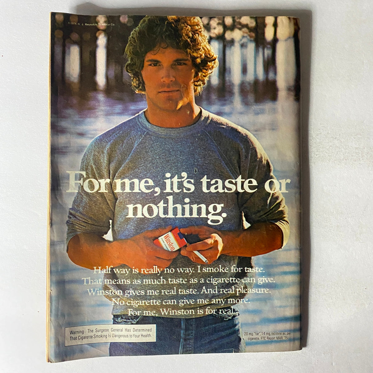 Back cover of the VTG Crawdaddy Magazine July 1975 displaying a vintage advertisement for Winston cigarettes along with a man promoting the brand, reflecting the advertising style of the 1970s.