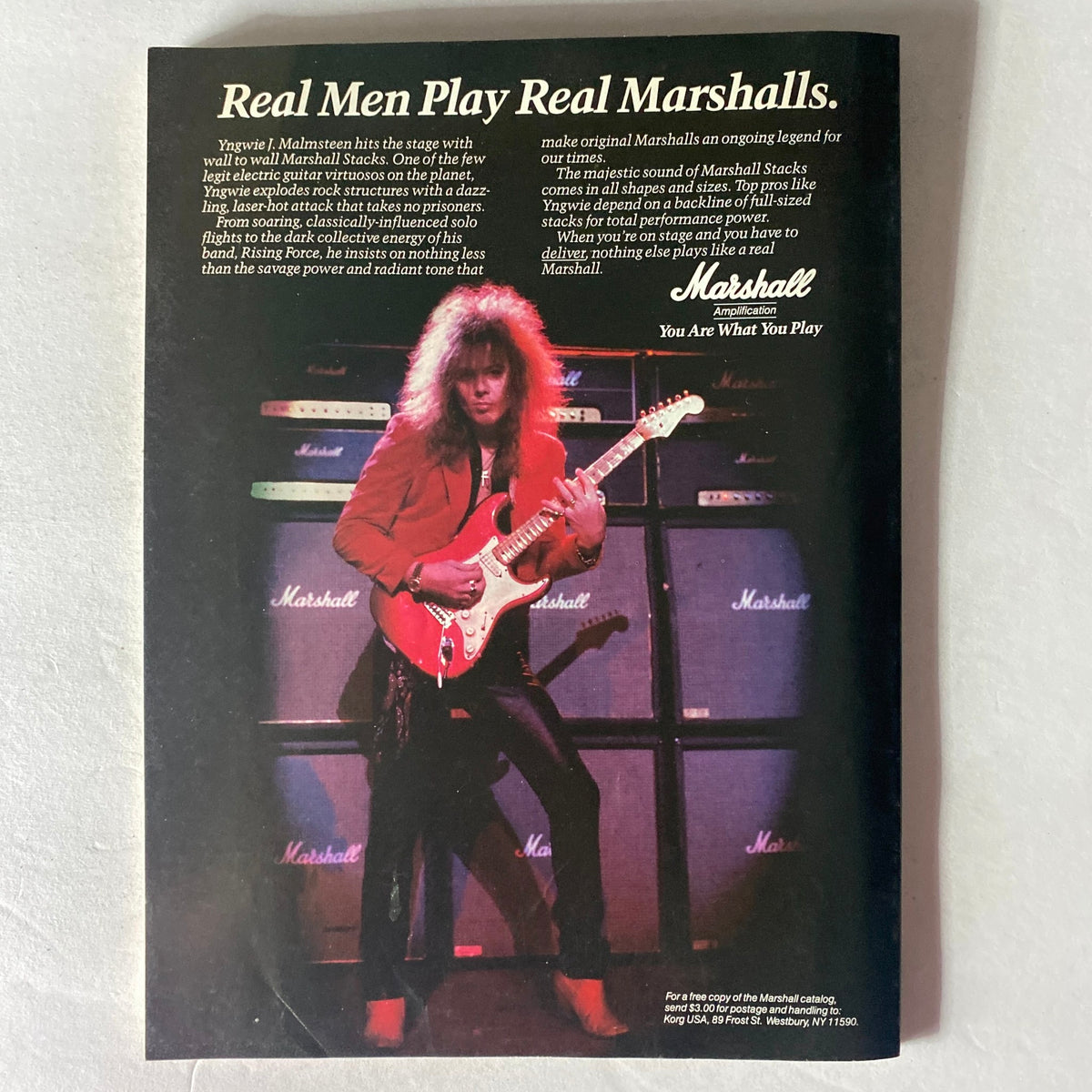 Guitar World Magazine March 1989 featuring Izzy and Slash, showcasing Yngwie Malmsteen performing with a red guitar in front of vintage Marshall amplifiers, emphasizing the tagline 'Real Men Play Real Marshalls.' A vintage rock music collectible.
