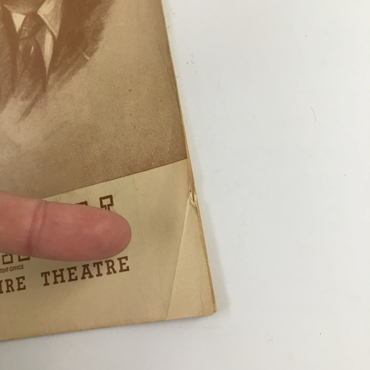Close-up of the corner of a 1946 Playbill for The Empire Theatre presenting Lynn Fontanne in O Mistress Mine, showing minor wear and creases, indicative of its vintage condition.