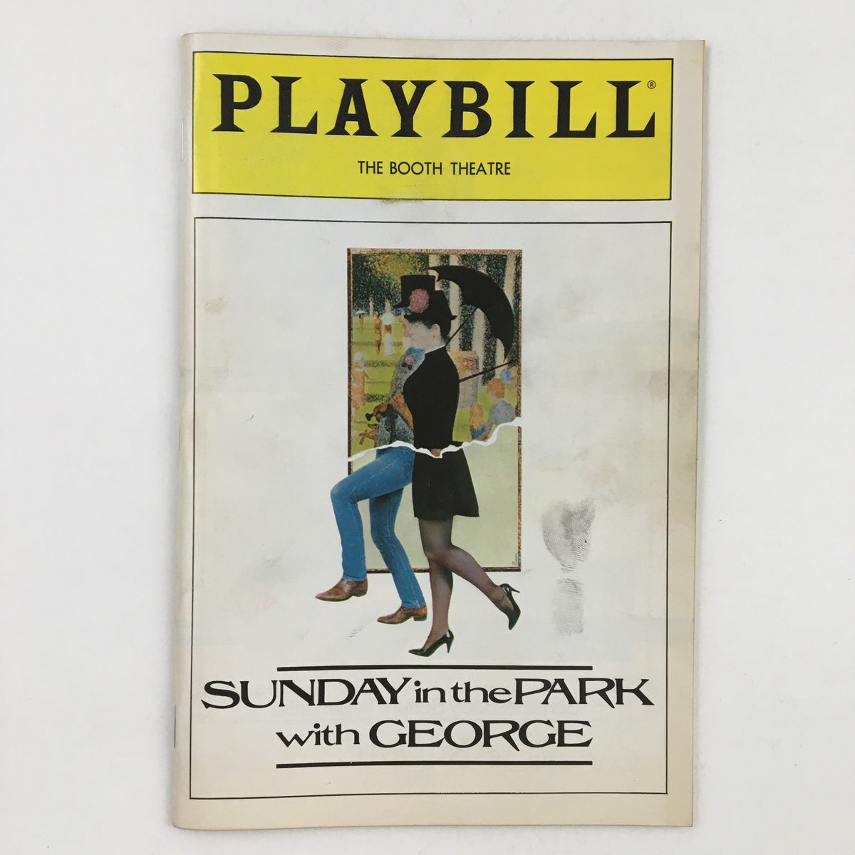 1984 Playbill for 'Sunday In The Park With George' featuring vibrant cover art from The Booth Theatre, showcasing a woman in a stylish outfit and an umbrella, capturing the essence of the theatrical performance.
