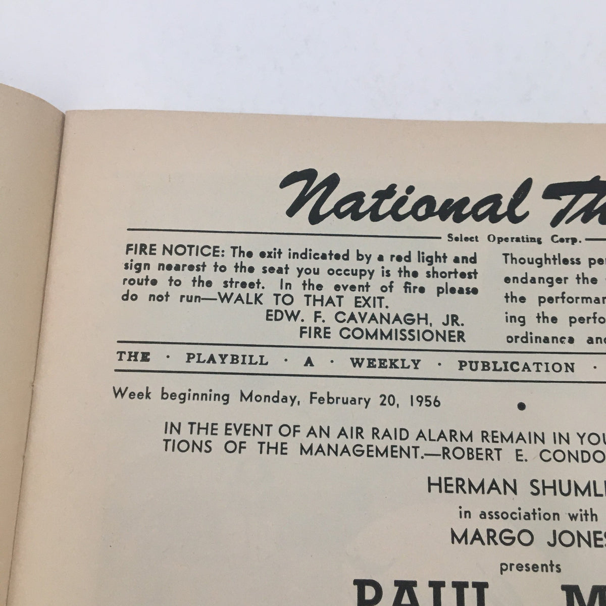 Interior view of a 1956 Playbill for National Theatre featuring Paul Muni in Inherit The Wind. The image showcases the opening page with the theatre's logo and performance details.