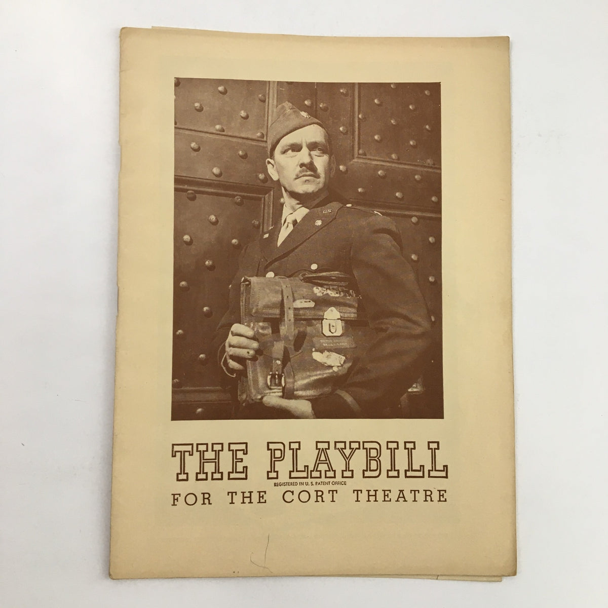 1945 Playbill for A Bell For Adano showcasing a man in military attire holding a bag, commemorating the Cort Theatre production.
