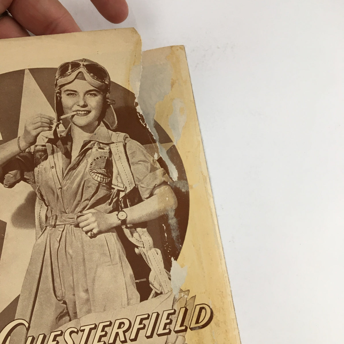 Back cover of the 1943 Playbill from John Golden Theatre with a vintage advertisement and slight damage.