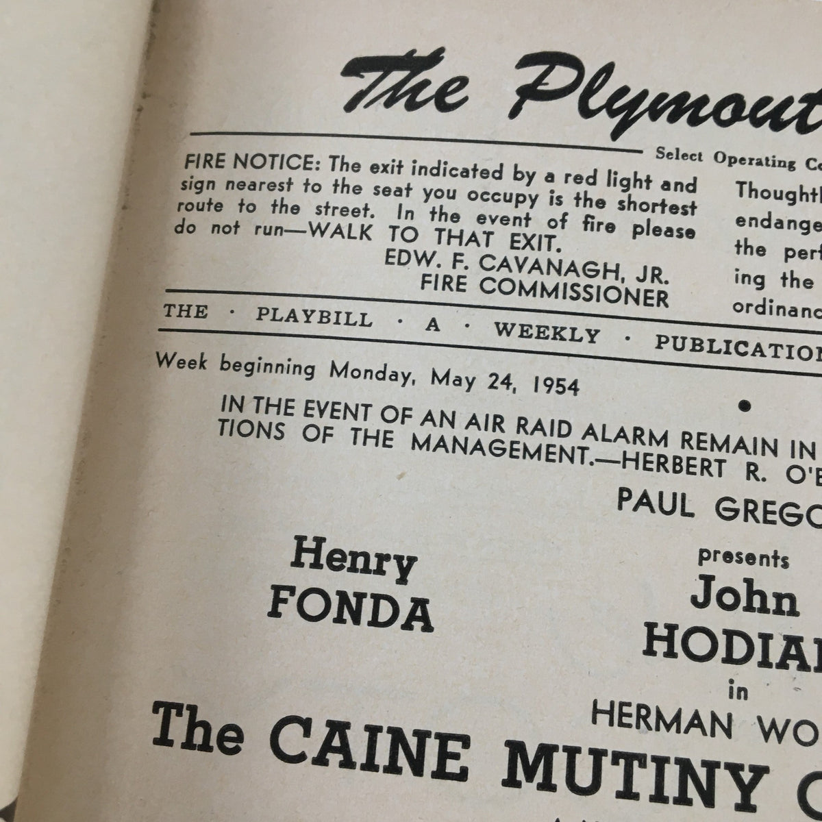 Close-up of the 1954 Playbill for The Plymouth Theatre's presentation of The Caine Mutiny Court Martial, showcasing details on the fire notice and cast information, reflecting the theatrical history of mid-20th century America.