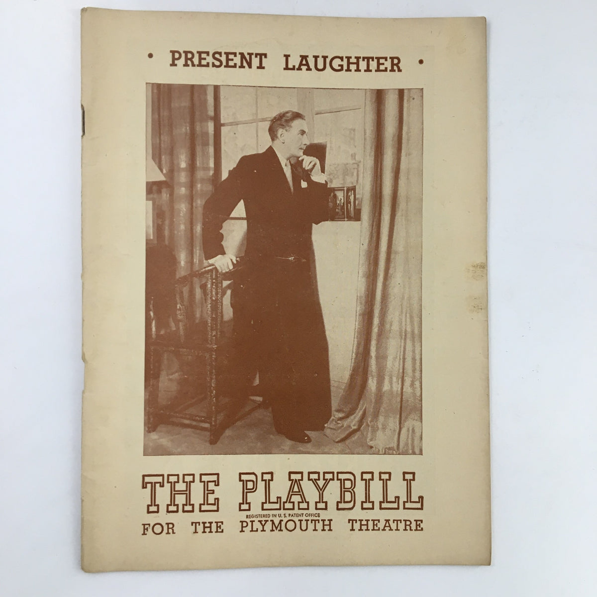 1946 Playbill for Present Laughter featuring Clifton Webb at The Plymouth Theatre, showcasing a vintage theatrical cover design.