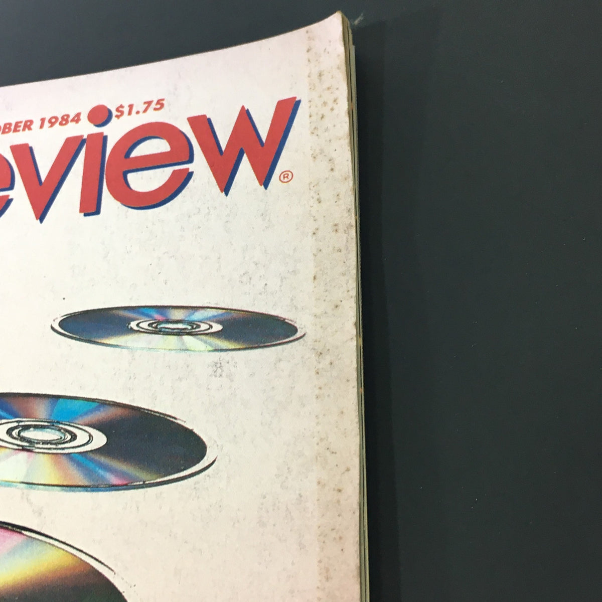 Side view of the October 1984 VTG Stereo Review Music Magazine displaying its slightly worn spine and iconic title with compact discs graphic.