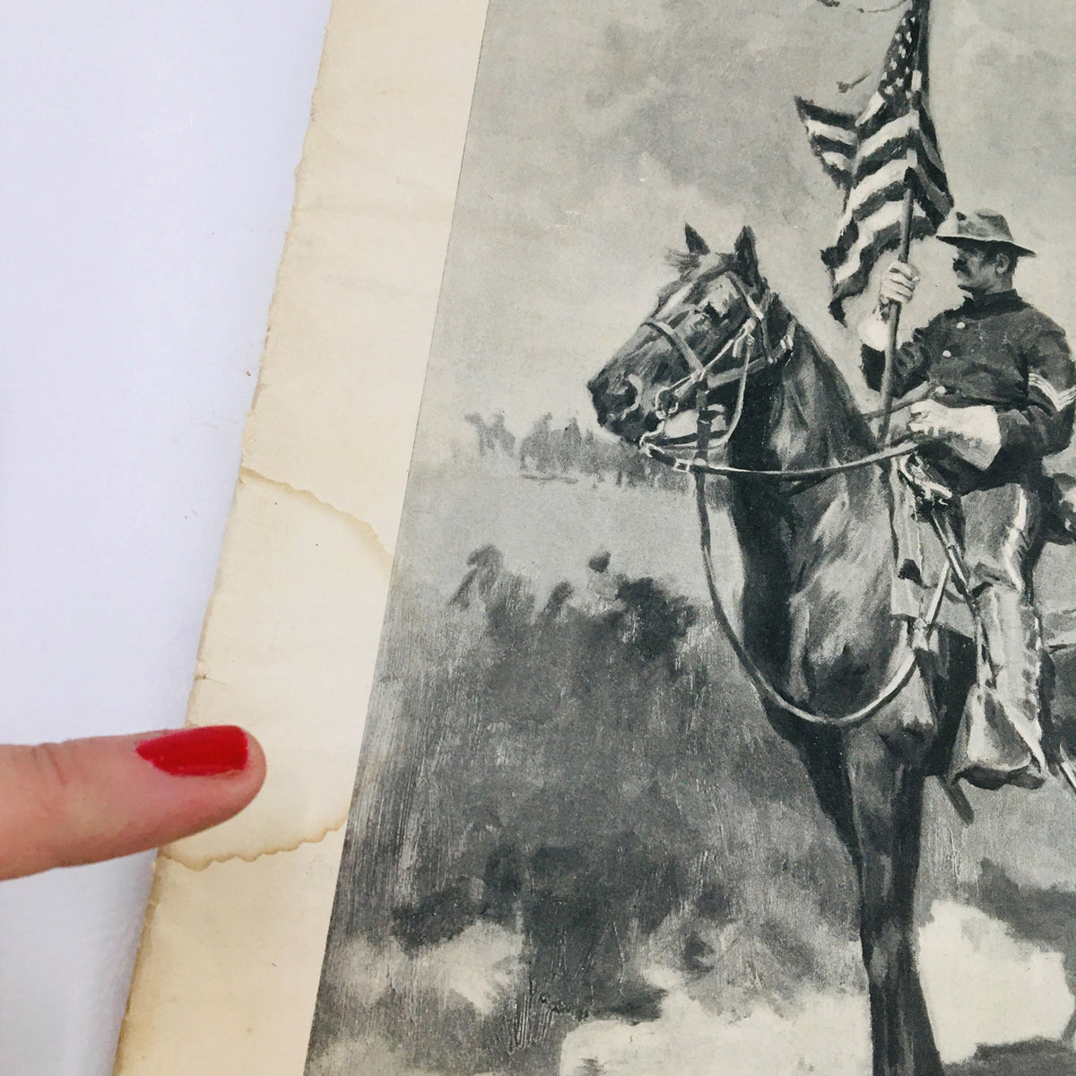 Close-up view of the edge of the Collier's Weekly May 21, 1898 magazine, highlighting minor wear and damage, featuring an illustration related to the American Victory at Manila.