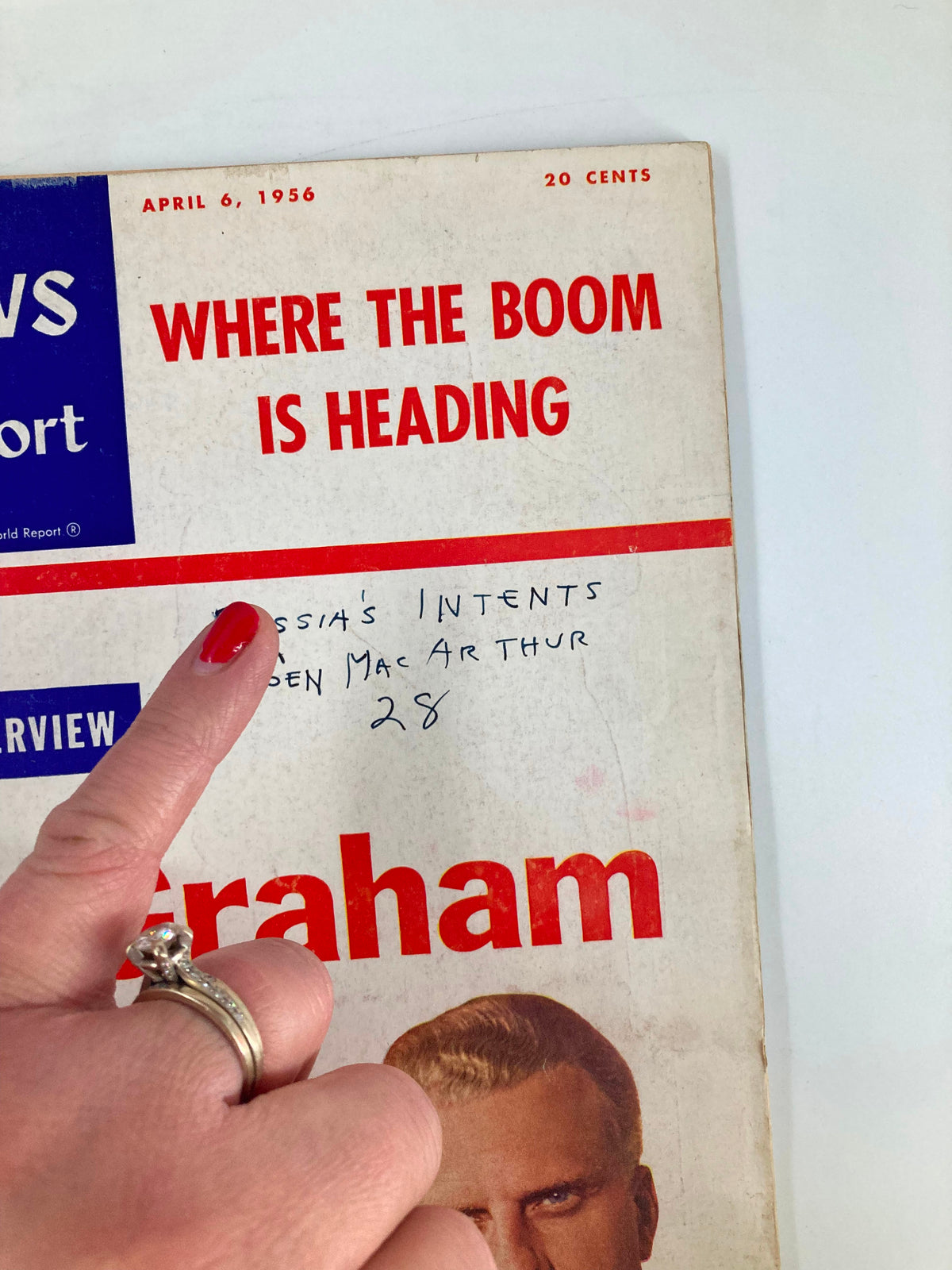 Close-up view of the US News & World Report Magazine cover from April 6, 1956, showcasing Billy Graham and handwritten text regarding General MacArthur.
