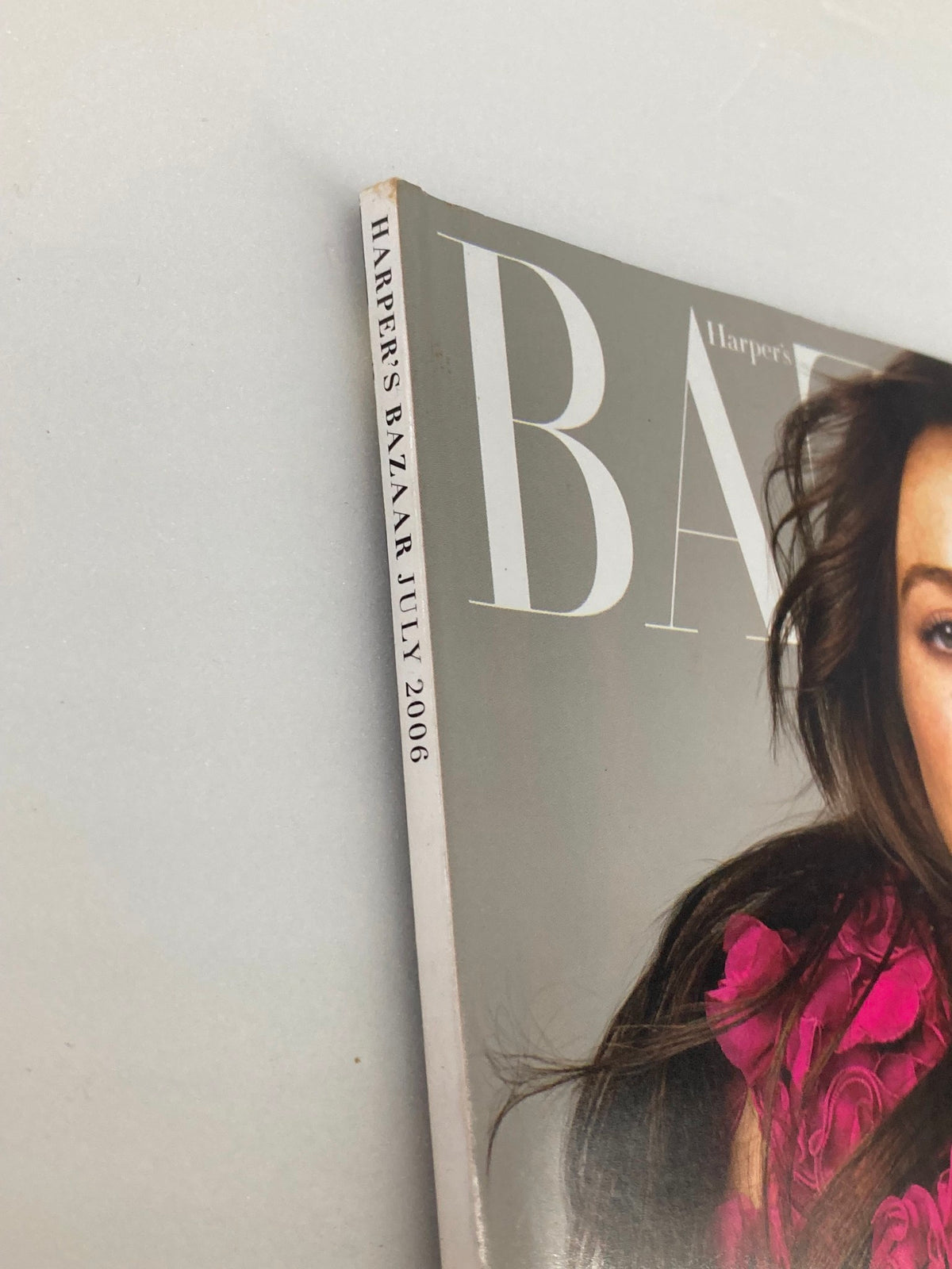 Cover of Harper's Bazaar Magazine July 2006 featuring Lindsay Lohan, showcasing bold typography and vibrant fashion elements.