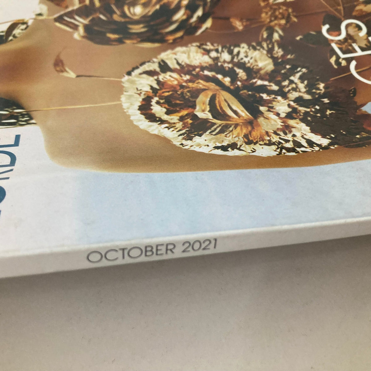 Side view of Vogue Magazine October 2021 displaying the date 'October 2021' near the spine of the magazine.