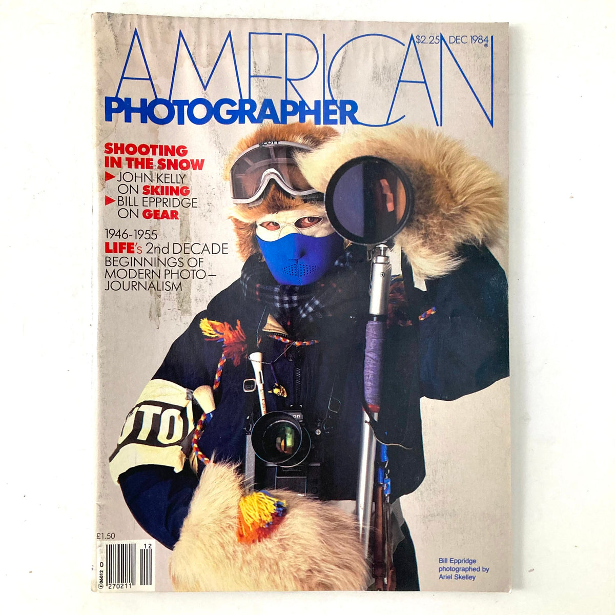 Cover of American Photographer Magazine December 1984 featuring a winter-themed photograph with a person in fur-lined clothing, goggles, and a blue face covering, prominently showcasing Bill Eppridge as the featured photographer.