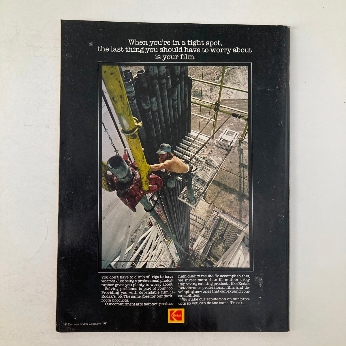 Back cover of American Photographer Magazine March 1982 featuring an advertisement for Kodak film with a visual of workers on a construction site, emphasizing film reliability in professional photography.