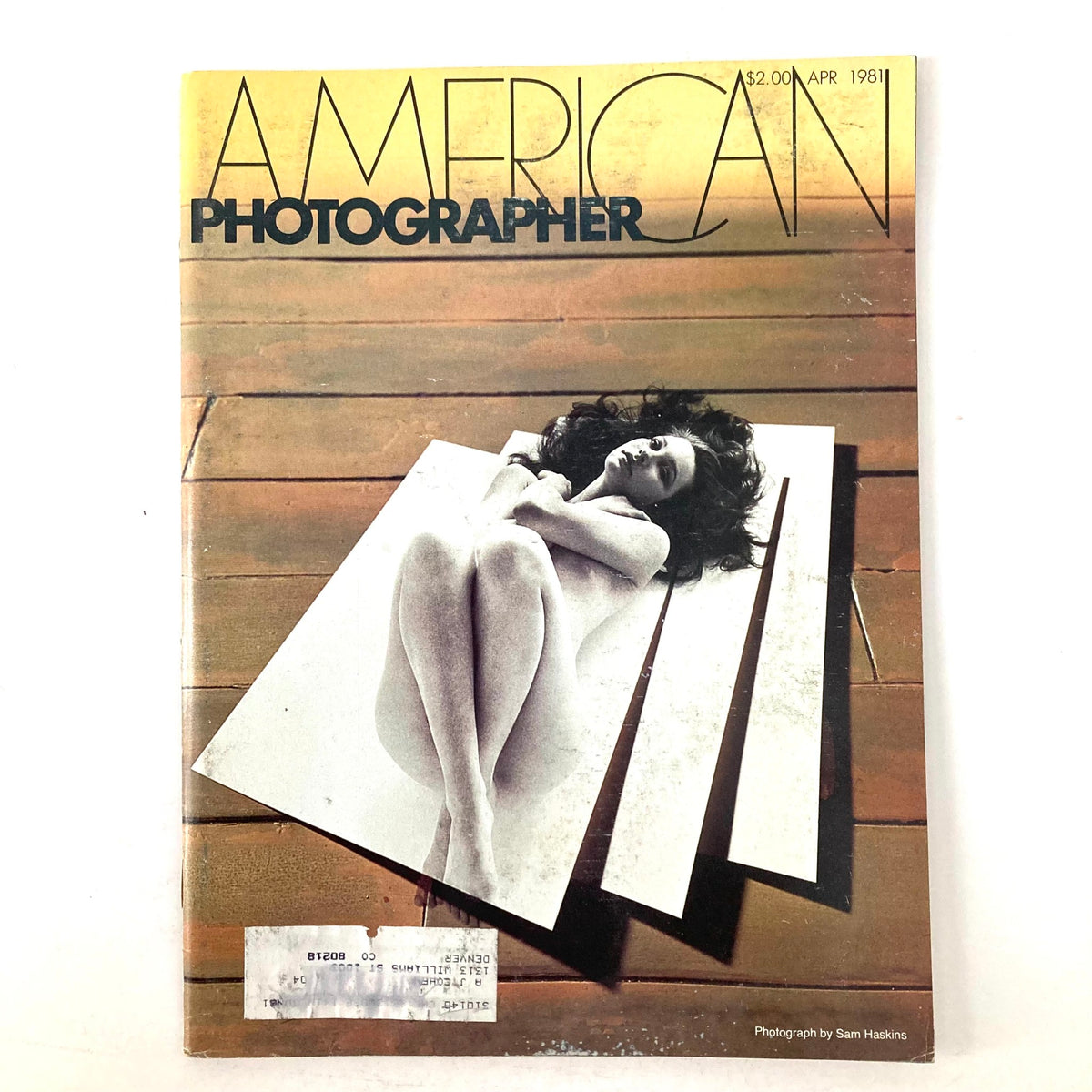 Cover of American Photographer Magazine April 1981 featuring a black-and-white photograph of a model by Sam Haskins on a wooden background. The magazine focuses on black-and-white photography techniques.
