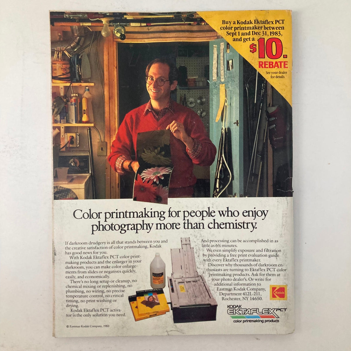 Advertisement page in American Photographer Magazine November 1983 showcasing Kodak Ektaflex PCT color printmaking products with a smiling man in a workshop. The ad emphasizes the ease of color printmaking for photography enthusiasts.