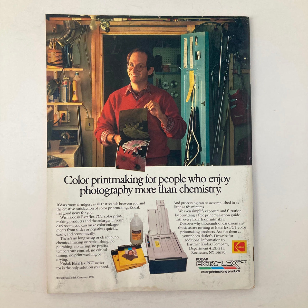 Back page advertisement of American Photographer Magazine February 1983 promoting Kodak color printmaking products with a smiling man in a photography setting.
