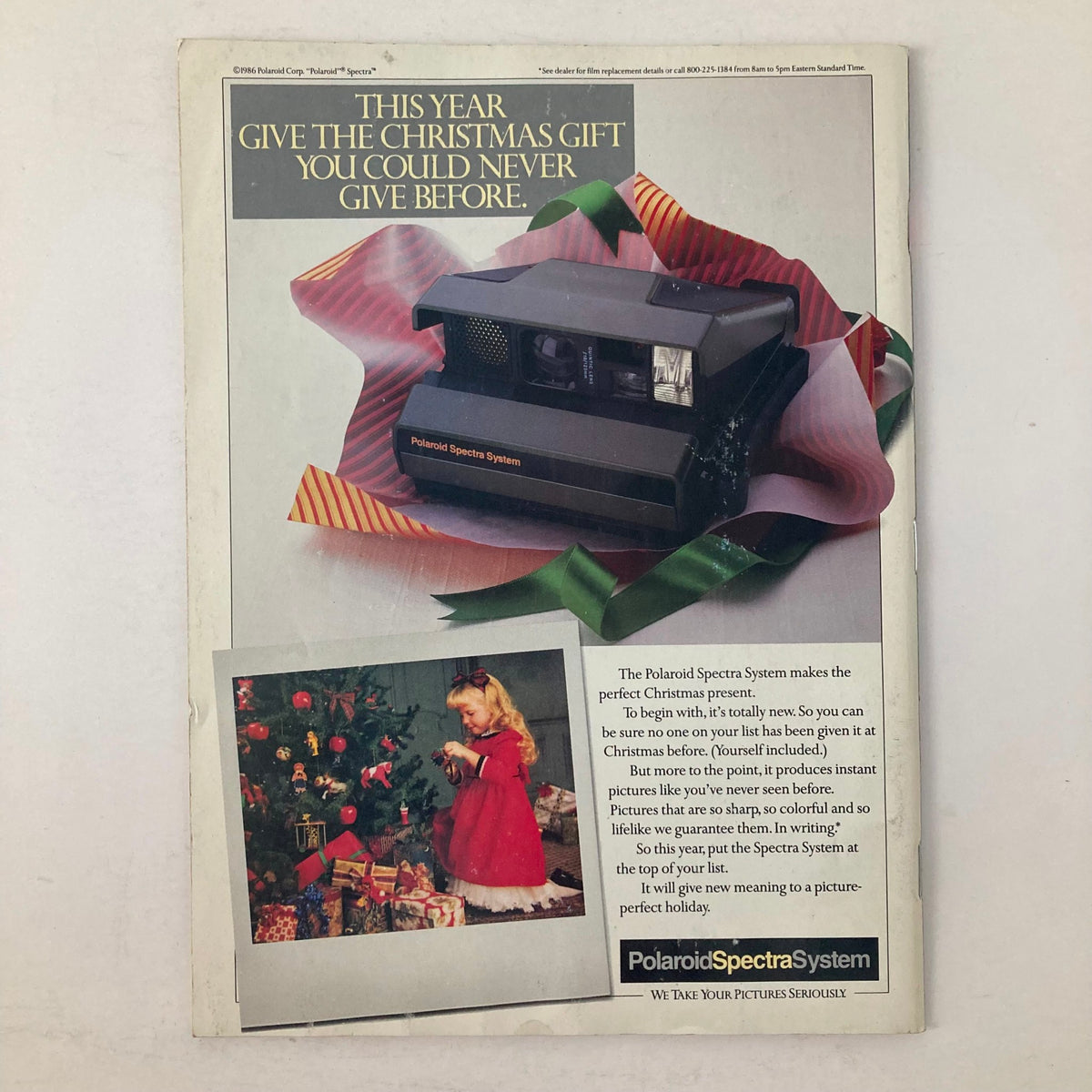 Advertisement for Polaroid Spectra System from American Photographer Magazine December 1986 featuring a Christmas gift theme, showcasing the camera and a young girl by a Christmas tree.