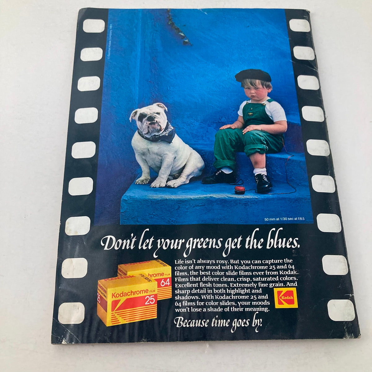 Cover of American Photographer Magazine January 1985 showcasing a young boy and a bulldog against a vibrant blue backdrop, accompanied by an advertisement for Kodak Kodachrome film. This vintage magazine features striking images and insights into 1980s photography.