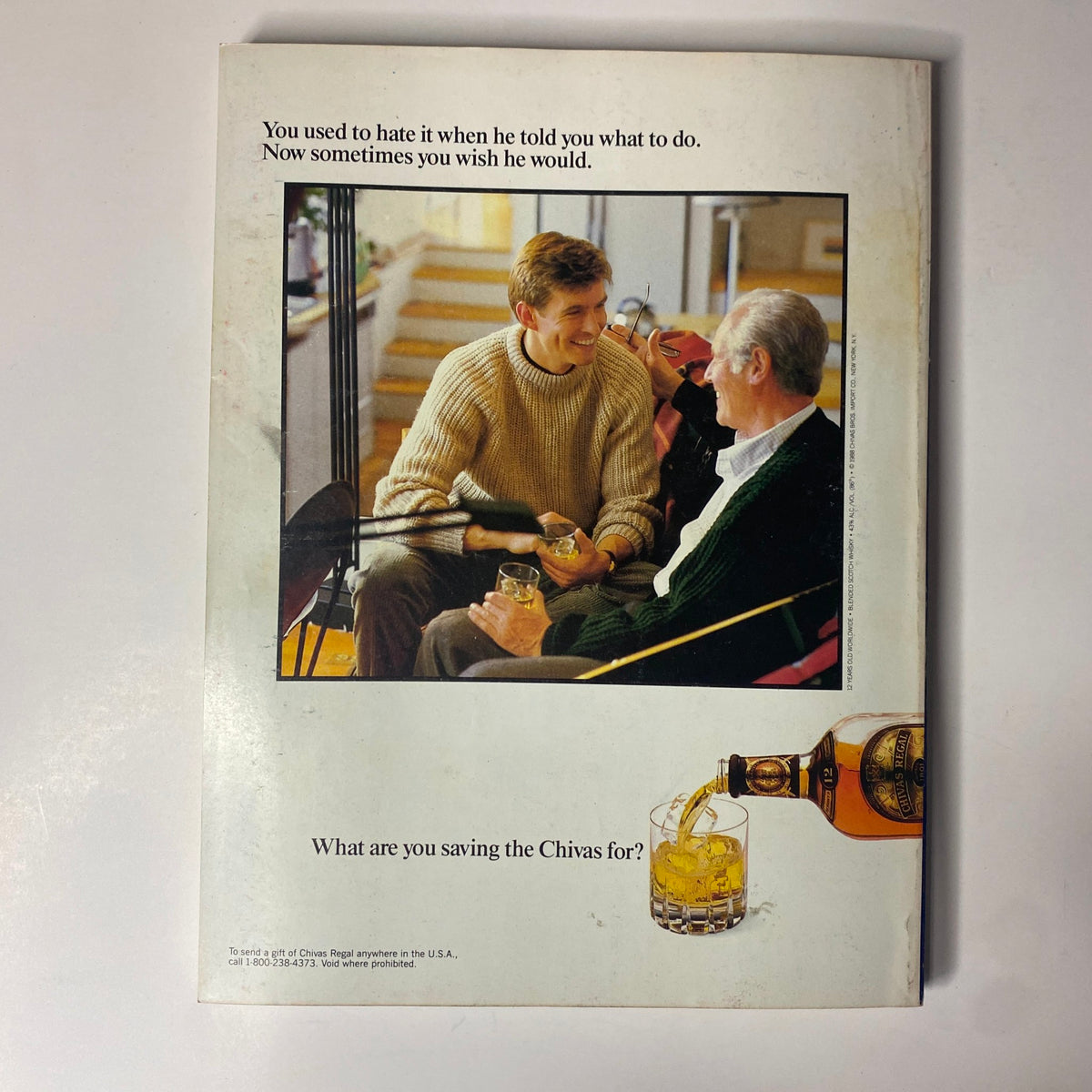 Back cover of Forbes Magazine, May 1, 1989, featuring an advertisement for Chivas Regal whiskey, depicting a conversation between a young man and an older gentleman.