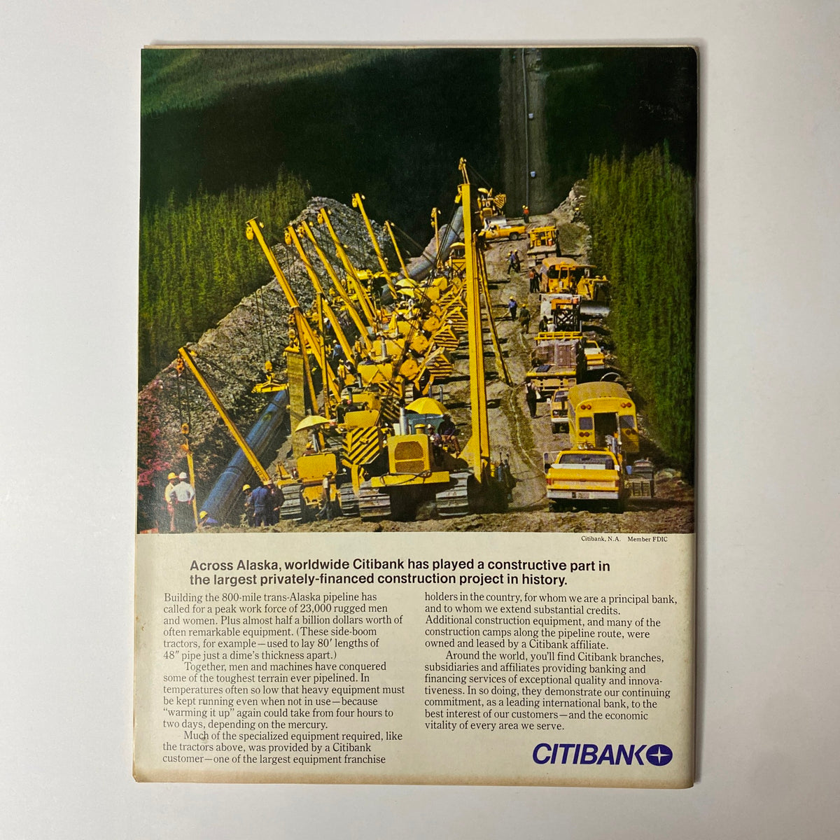 Forbes Magazine April 1, 1977 advertisement highlighting Citibank's role in the largest privately-financed construction project in history, showcasing heavy machinery and workers along an Alaskan pipeline.