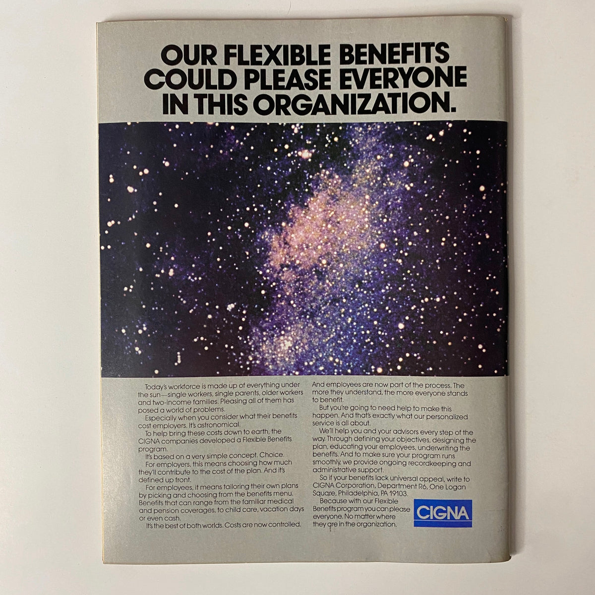 Back cover advertisement of Forbes Magazine April 7, 1986 showcasing Cigna's flexible benefits program with a cosmic background design.