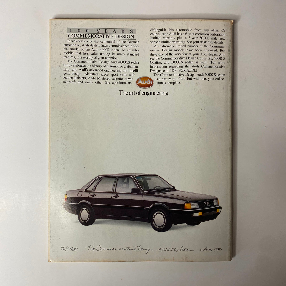 Back cover of Forbes Magazine April 21, 1986, showcasing a commemorative design for the Audi 4000CS sedan. The design emphasizes automotive craftsmanship and engineering with a detailed description and image of the car.