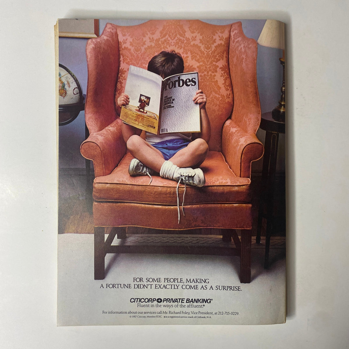 A vintage advertisement from the 1988 Forbes Magazine featuring a child reading the magazine, promoting Citicorp Private Banking.
