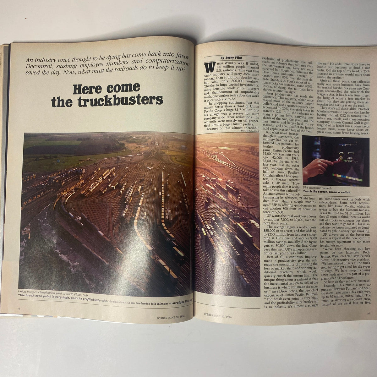 Inside spread of Forbes Magazine June 30, 1986 showcasing the cover story 'Here Come The Truckbusters', examining the resurgence of railroads in freight transport with accompanying imagery.