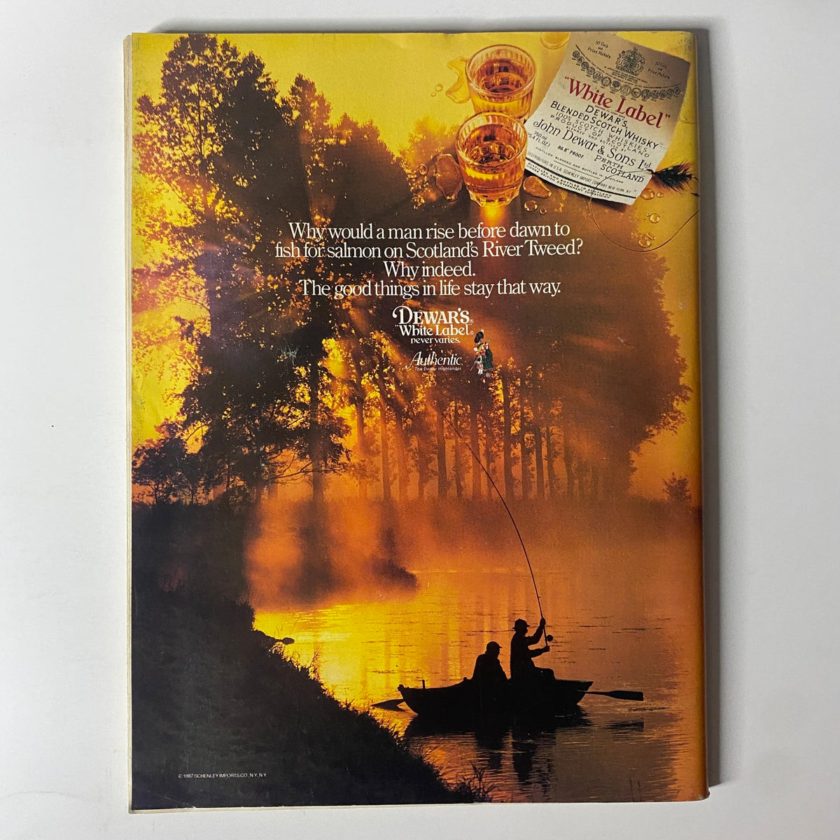 Forbes Magazine June 15, 1987 back cover displaying an advertisement for Dewar's White Label whisky, featuring a scenic sunset fishing scene with the tagline about enjoying the good things in life.