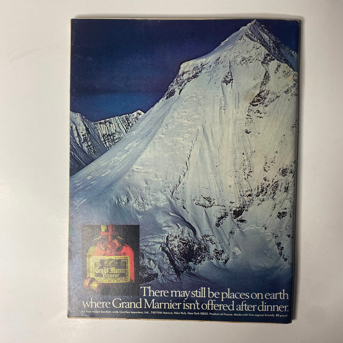 Back cover of Forbes Magazine dated October 15, 1977, showcasing an advertisement for Grand Marnier with a striking mountain background and a promotional message.