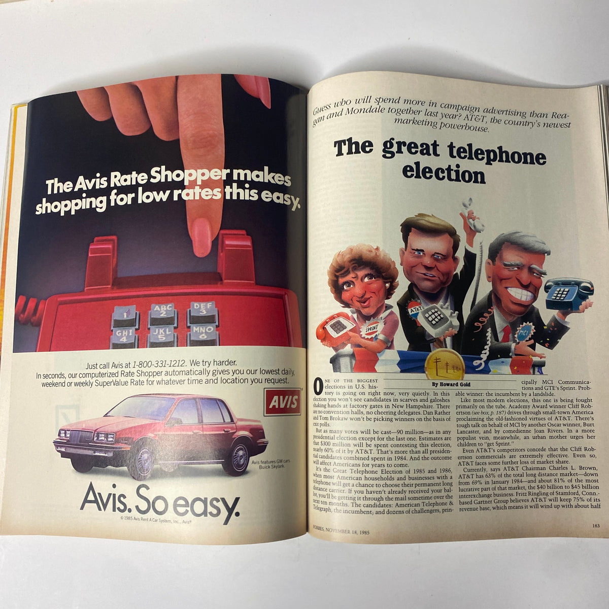 An article spread from Forbes Magazine November 18, 1985, discussing 'The Great Telephone Election' with visuals related to the telecom industry and advertising.