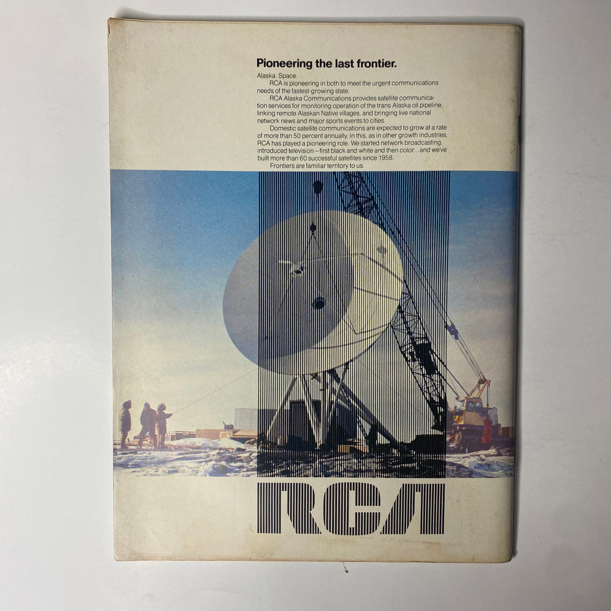Cover image of Forbes Magazine from May 1, 1977, titled 'Crunch In The Caribbean' showcasing a satellite communication system in Alaska, highlighting RCA's advancements in technology, with a snowy landscape and silhouetted figures in the background.