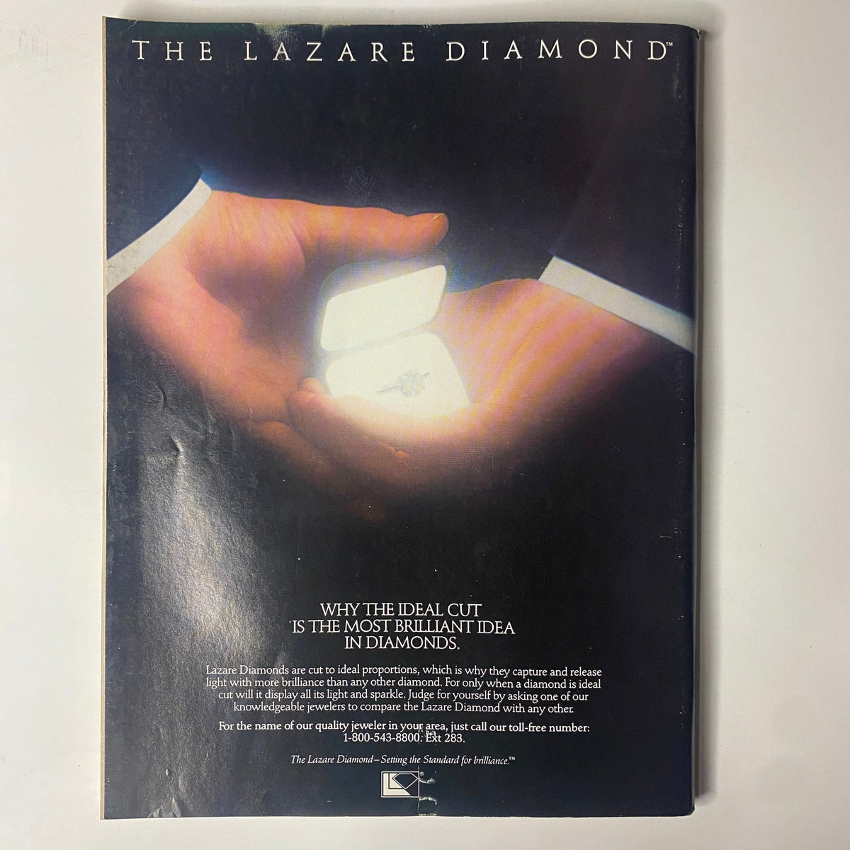 Advertisement page from Forbes Magazine December 1, 1986 for Lazare Diamonds, highlighting the significance of ideal diamond cuts with a visual representation of an opened ring box.