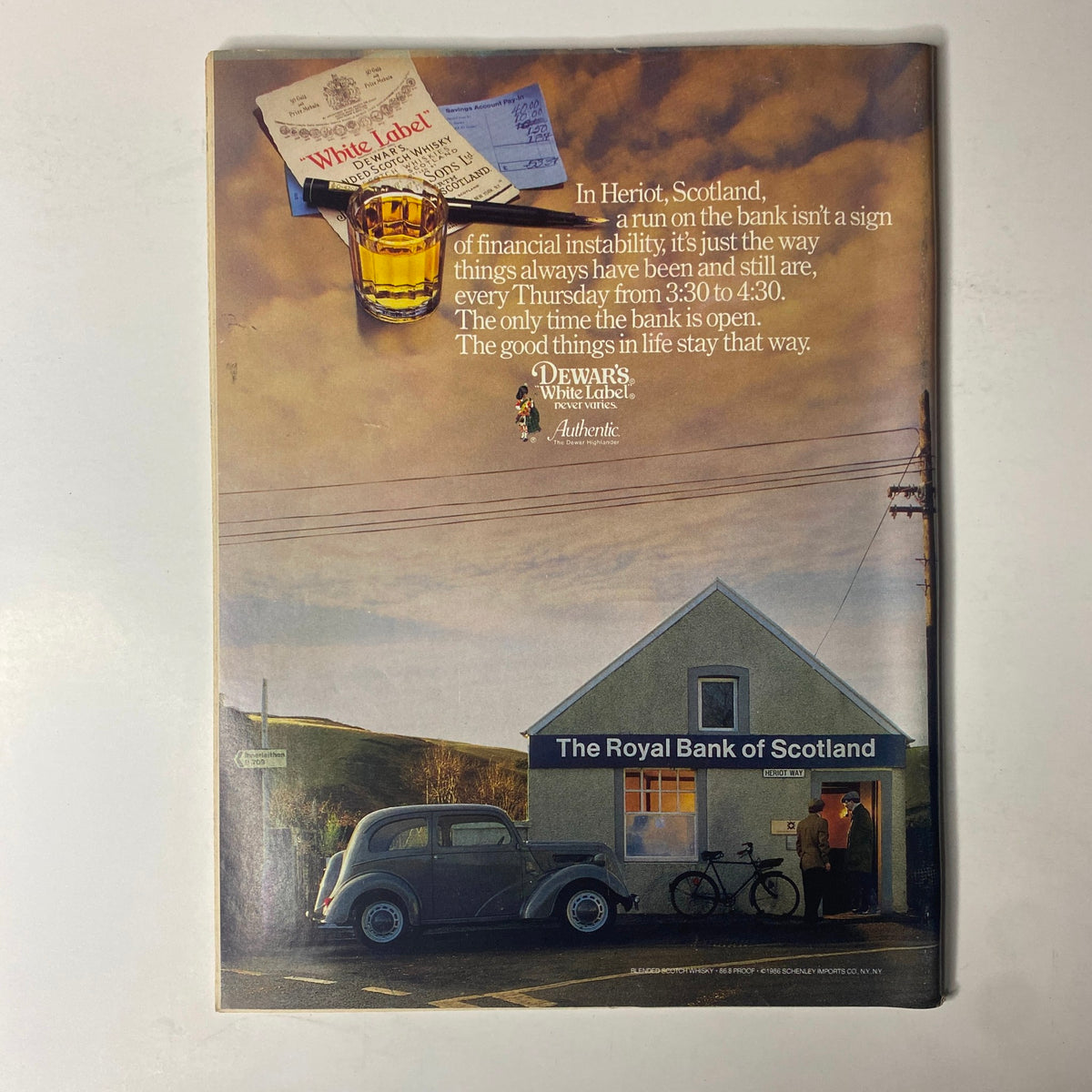 Advertisement from Forbes Magazine January 26, 1987 for Dewar's White Label with a scenic view of the Royal Bank of Scotland and traditional elements.
