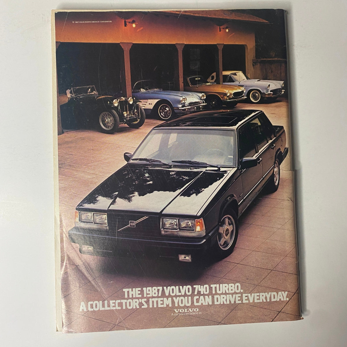 Cover of the vintage Forbes Magazine from May 18, 1987, featuring the headline 'Japan: The Land Of The Rising Stocks,' showcasing a black 1987 Volvo 740 Turbo parked in front of classic cars, symbolizing economic prosperity and collector's value.