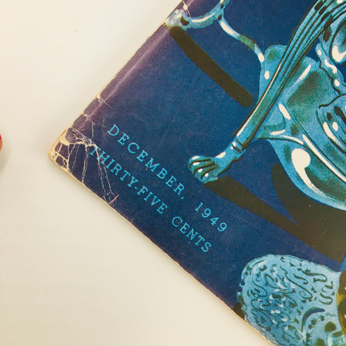 Detailed shot of the corner of Gourmet Magazine December 1949, displaying publication date and price, emphasizing the magazine's authenticity as a collectible item.