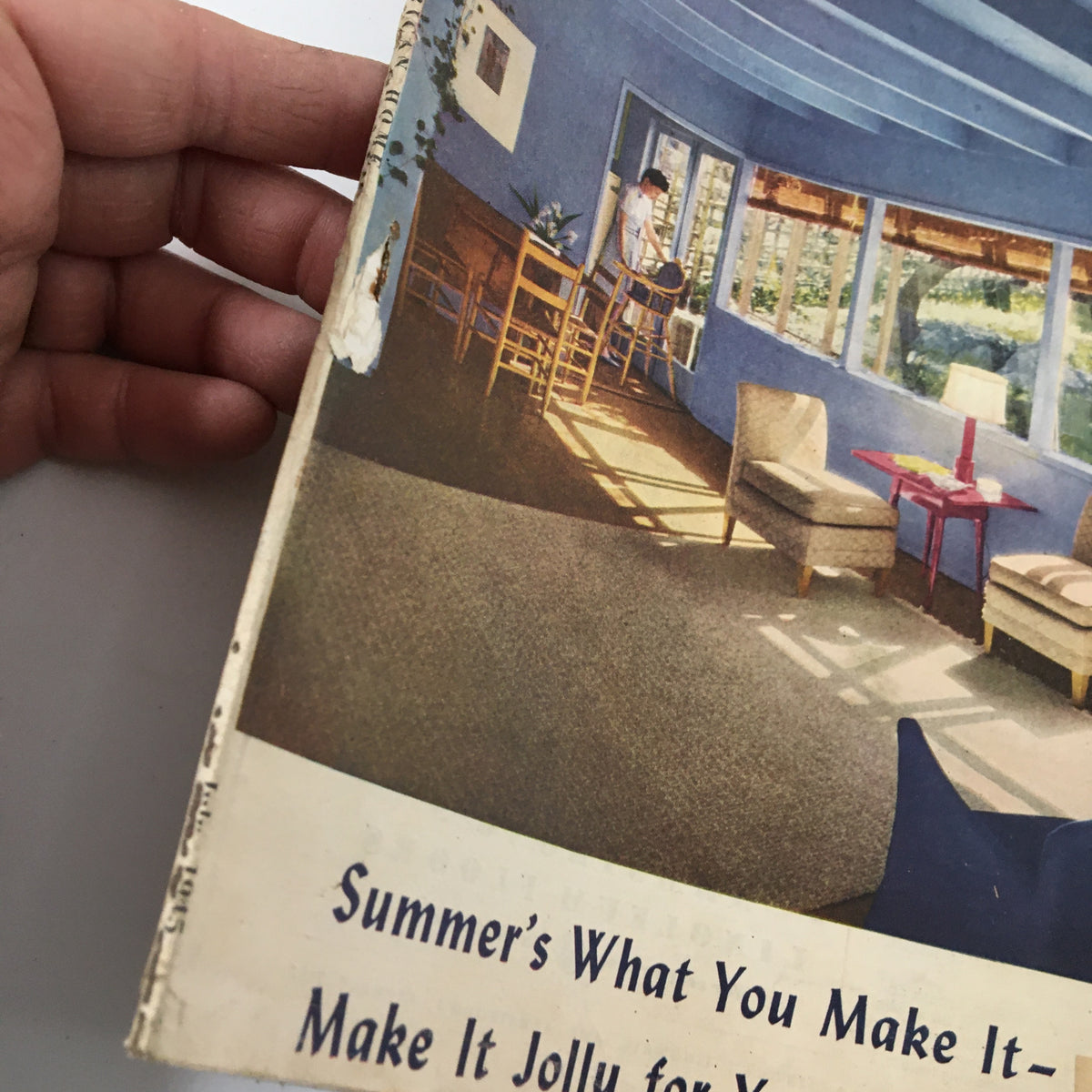Cover of VTG The American Home Magazine July 1945 depicting a vibrant living space with a woman cleaning by the window, showcasing summer themes and home decor.