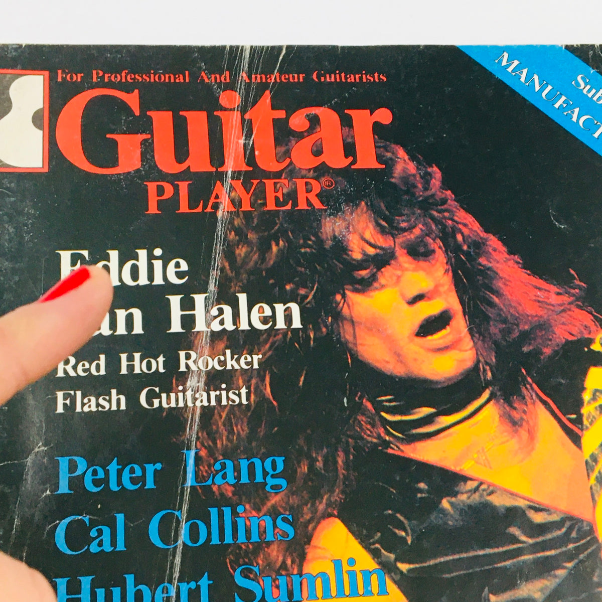 Close-up view of Guitar Player Magazine April 1980 cover highlighting Eddie Van Halen, with additional text about prominent guitarists Peter Lang and Cal Collins.