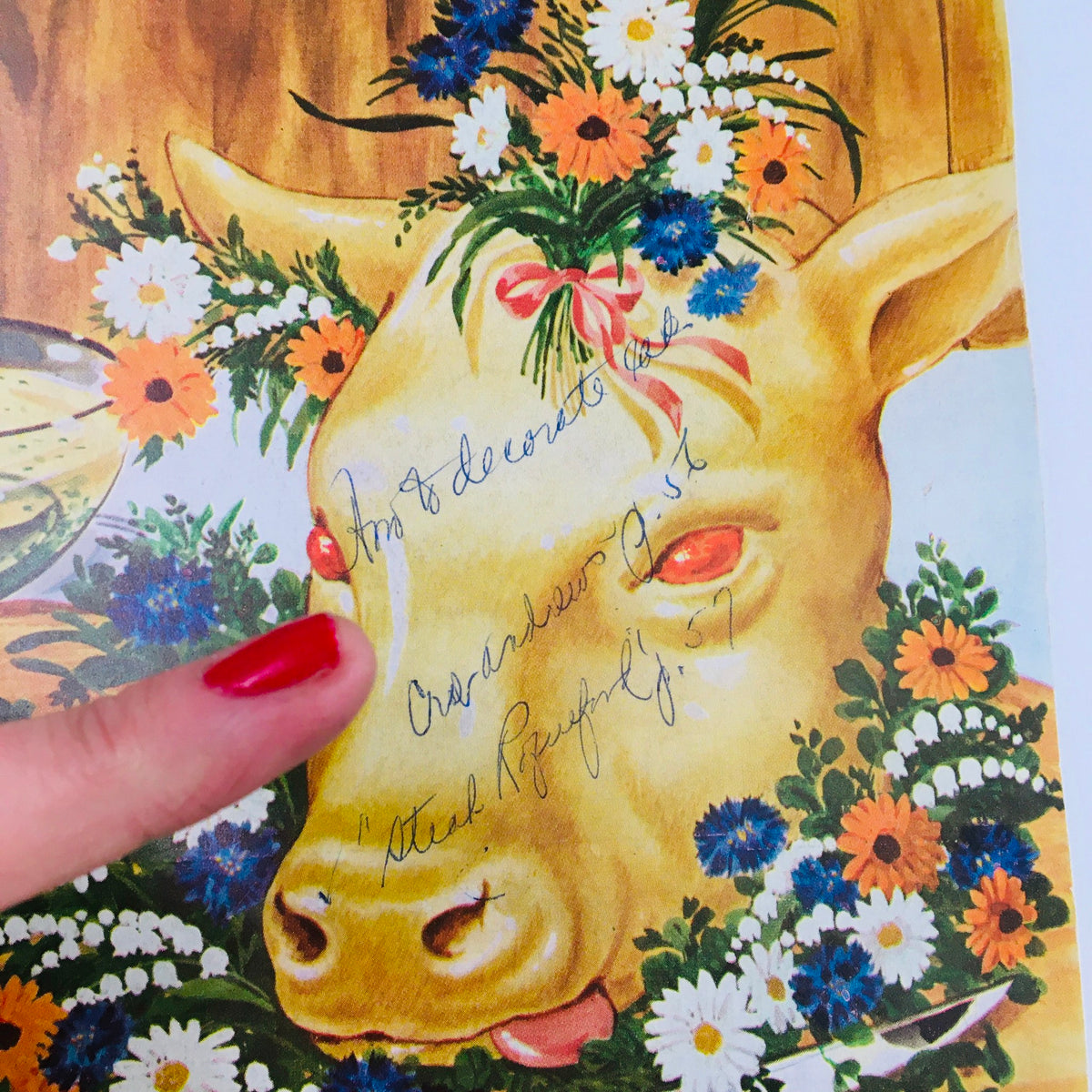 Close-up of the floral adorned pig's head on the cover of Gourmet Magazine February 1954, highlighting the artistic details and handwritten notes.