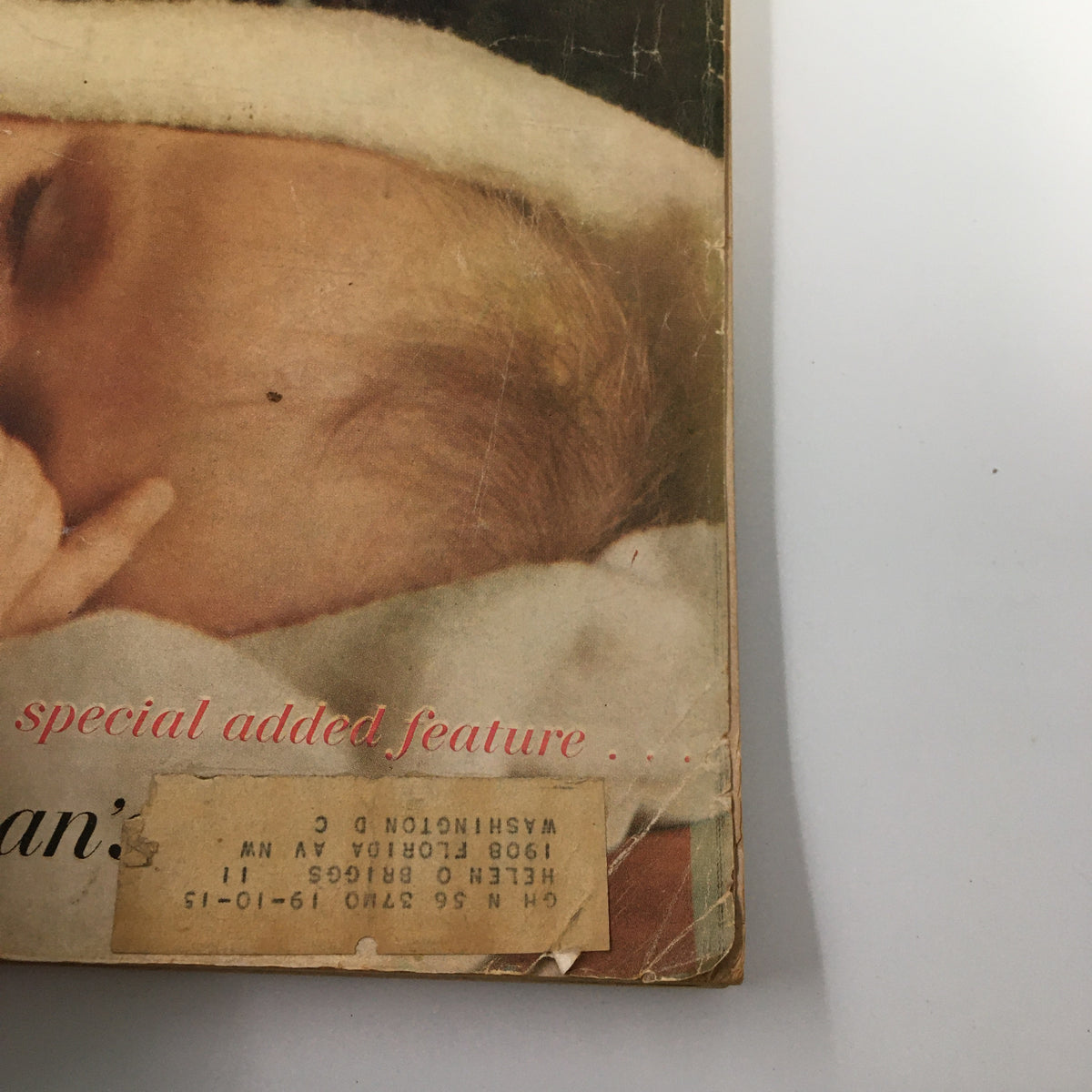 Close-up of the cover of Good Housekeeping March 1956 highlighting an infant and a special added feature, reflecting mid-20th century parenting.