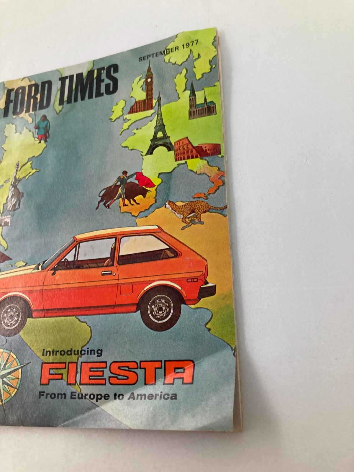 Cover of VTG Ford Times Magazine September 1977 featuring the Ford Fiesta, highlighted with illustrations of Europe and the words 'Introducing Fiesta From Europe to America'.